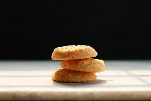 Cookies on a white table with a black background, shallow depth of field photo