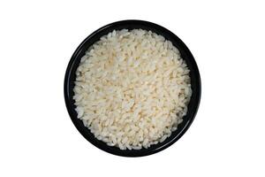 Rice in black bowl isolated on white background with clipping path. photo