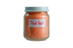 Glass jar of pink salt isolated on a white background. Clipping path photo