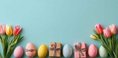 Colorful Easter eggs and tulips arranged on a blue background during spring season festivities photo