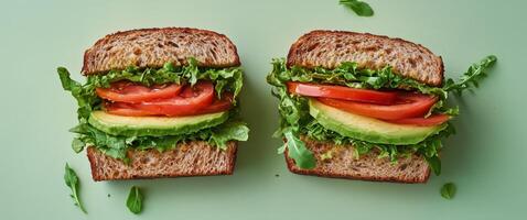 Fresh vegetable sandwich with lettuce, tomato, and cucumber on whole grain bread photo