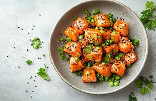 Fresh salmon cubes garnished with green onions and sesame seeds for a healthy meal option photo