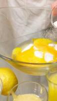 Stand mixer, adding a teaspoon of natural vanilla essence with a red measuring spoon video