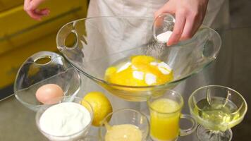 Stand mixer, adding a teaspoon of natural vanilla essence with a red measuring spoon video