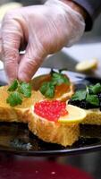 sandwiches with Rick caviar pike caviar sturgeon and salmon croquettes add lemon to sandwich garnish with lemon and herbs video