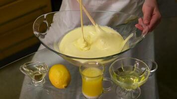 Whisking cake batter in a glass bowl, in the process of baking a cake. video