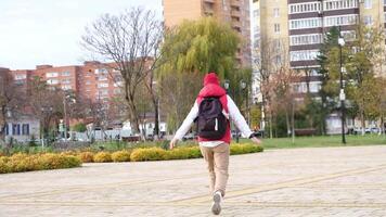excited traveler woman running and spinning happily in city street, sightseeing, exploring new city, slow motion video