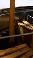 Filling the electric honey extracting machine with wooden frames. Male hands place the frames close to each other in the centrifuge equipment. Vertical video