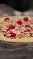Pizzeria master making pizza. Chef pulling pizza at the oven using the pizza spatula. Food preparation concept Vertical video