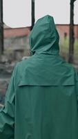 Survivor in radioactive zone. Frightened woman in protective suit and gas mask standing in abandoned place and looks on camera. Technogenic catastrophe. Vertical video