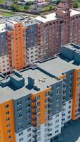 Multi-storey apartments in new area. Construction of a modern residential complex. Modern high rise architecture. Aerial view. Vertical video