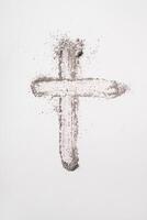 Ash cross symbol on white background for lent and religious reflection. Ash Wednesday photo