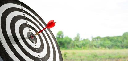 target board with dart on playing field background photo