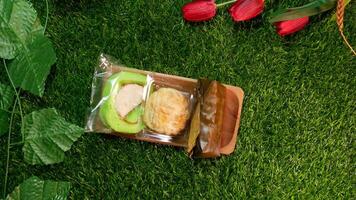 Top View Traditional Indonesian snacks, various types of sweet and delicious snacks such as cream puffs, roll cakes, and lemper which are commonly known as kue with Natural Decorative Touches photo