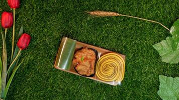Top view traditional Indonesian snacks, various types of sweet and delicious snacks such as roll cake, lemper, and fried tofu which are commonly known as cakes with a Natural Decorative Touch photo