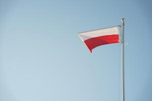 A flag of poland flying in the wind photo