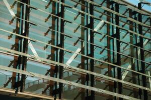 A building with many windows and a large glass wall photo