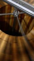 Lots of wooden frames being rotated in the centrifuge machine. Process of honey extraction in special apiary equipment. Close up. Top view. Vertical video