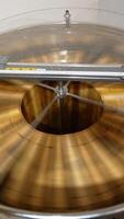 Centrifuge machine rotating honey frames to extract honey from cells. Beekeeper's equipment for collecting honey harvest. Top view. Vertical video
