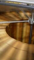 Quick rotation of wooden honey frames in the centrifuge machine. Electric equipment for honey harvesting at apiary. Vertical video