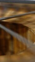 Frames with organic honey are rotated in the barrel-like centrifuge machine. Beekeepers extracting product from honey frames. Vertical video