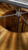 Honey extracting machine working. Honey frames are rotated in the apparatus to get fresh organic product. Close up. Vertical video
