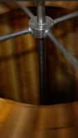 Centrifuge rotating quickly to extract honey from frames. Apiary machine for harvesting organic fresh honey. Vertical video