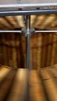 Process of honey extraction in the electric centrifuge device. Many wooden frames are rotated for taking honey out of cells. Vertical video