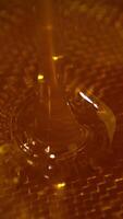 Freshly extracted honey flowing into the bowl. Close up. Healthy organic product filtering through the sieve. Vertical video