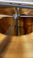 Quick rotation of honey frames inside the centrifuge. Wooden frames with honey combs spin to shake off liquid honey. Top view. Vertical video