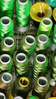 Collection of colorful threads. Different colors of threads in spools. Background of sewing threads. Handicraft concept. Vertical video