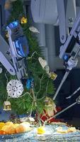 Futuristic robotic equipment for New year. Robotic arms peeling mandarin on table. Modern engineering. New machinery for Christmas preparation. Vertical video