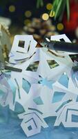 Robotic tool cutting paper snowflake. Smart robot making Christmas decorations. Modern intelligent equipment preparing for New Year. Vertical video