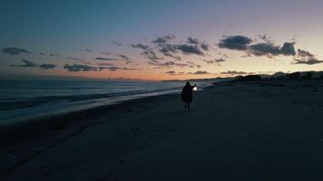 Mysterious man runs on the beach with a lantern video