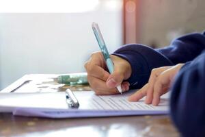 a students are taking exams to measure learning in the classroom. Soft and selective focus. photo