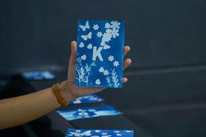Cyanotype cards or sunlight photographs are made from a negative copying process using iron particles that become ferrous due to the action of light. The result is a blue-toned photo. photo