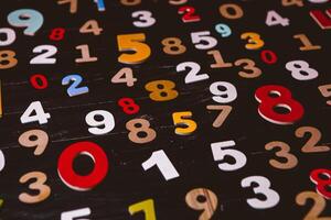 Numbers on a black wooden background. The concept of the number. photo