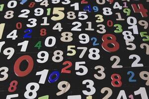 Numbers on a blackboard background. Multicolored background of numbers. photo