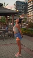 A Stylish Young Woman is Finding Joy and Admiration as She Enjoys the Beautiful Sunset video