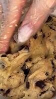 dark chocolate chip cookie dough making process Making and Mixing Chocolate Chip Cookies dough in a transparent glass bowl in 4K. Concept of Preparing Chocolate Chip cookies step by step. video