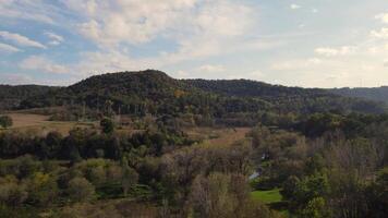 A view of a valley with trees and hills video
