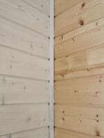 Contrast of untreated and treated wood planks showcasing natural grain patterns in a corner setting photo