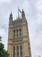 London, UK - 06.05.2019 View of the Victoria Tower with the UK flag in cloudy weather photo