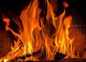 Flames of fire and hot coals of burned wood in the fireplace photo