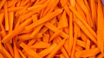 Coarsely chopped orange carrot. The process of cooking pilaf. Fresh natural vegetables background. photo
