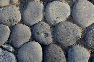 a close up of a stone wall with many different shapes photo
