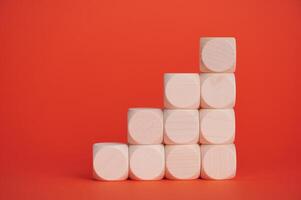 Wooden blocks arranged in a staircase pattern on a vibrant background photo
