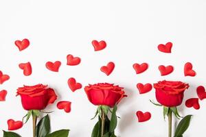 Frame from red hearts and roses on white background. Valentine's day greeting card. Layout with place for text. photo