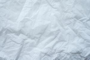 Full frame shot of crumpled tissue fabric texture and background. Tissue fabric is slightly rough and crisp in texture. photo
