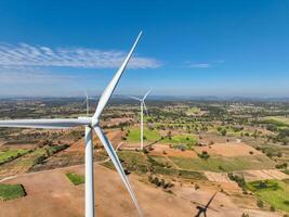 Wind energy and sustainable power generation with wind turbines, Eco-friendly solutions for renewable resources. Wind power farm and sustainable development of renewable energy. Green technology photo